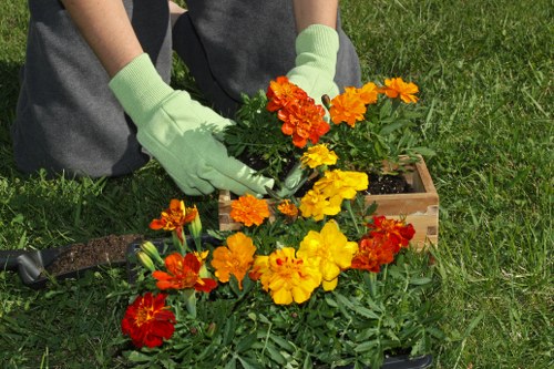Operator safely using gardening equipment with protective gloves